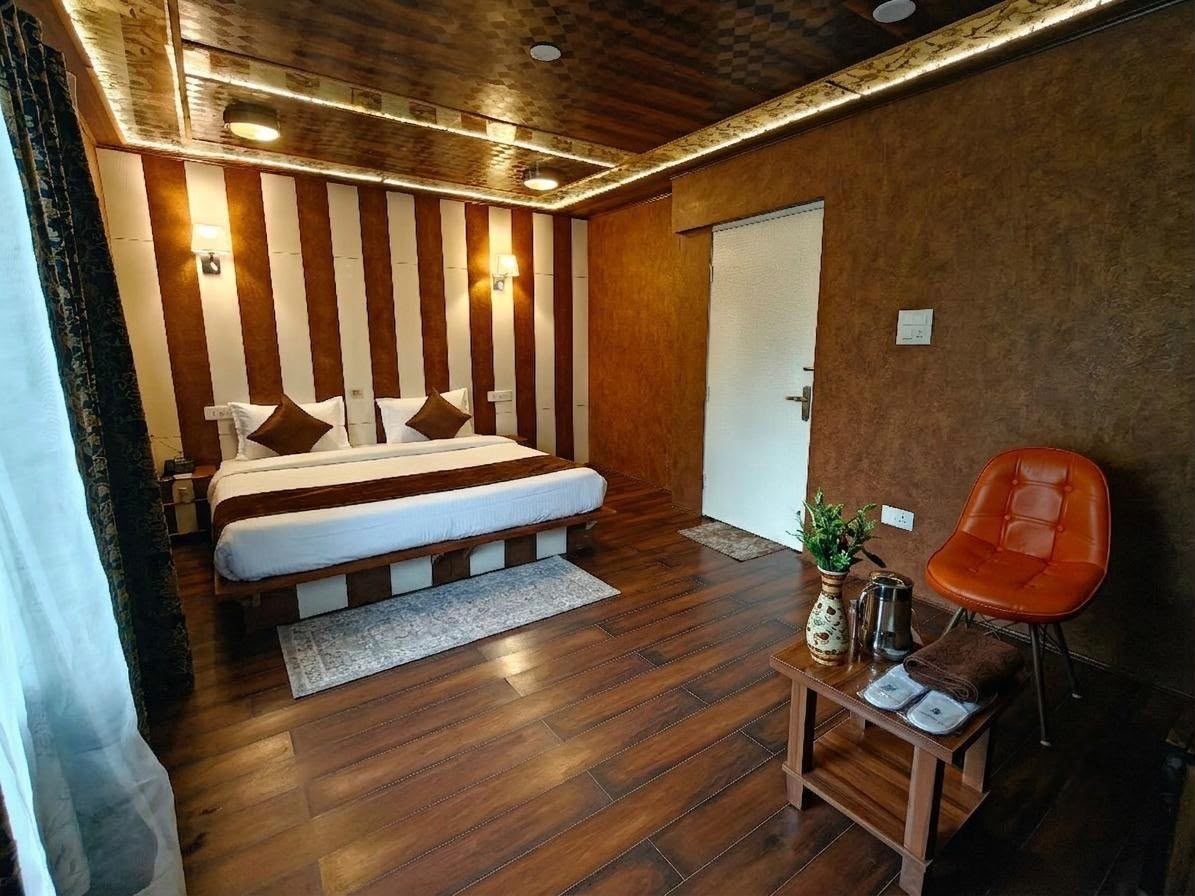 The Forest Room — wood-panelled bedroom with a window to the trees